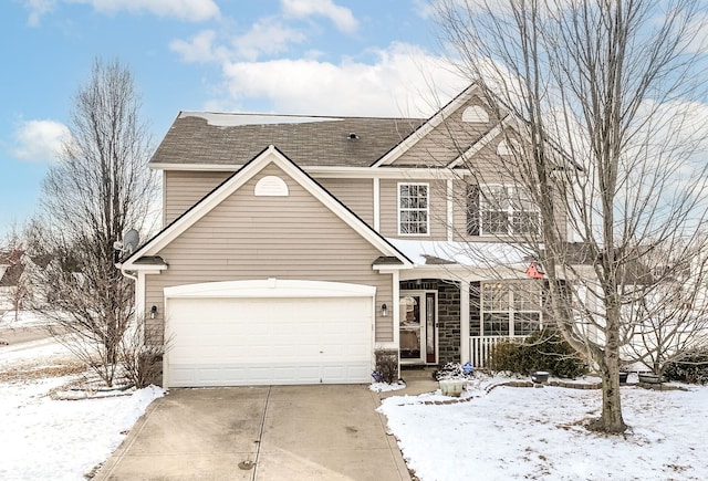 traditional home with a porch, concrete driveway, and an attached garage