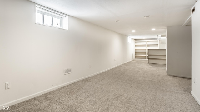 basement with light colored carpet