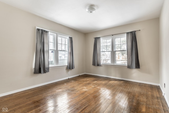 spare room with dark hardwood / wood-style flooring