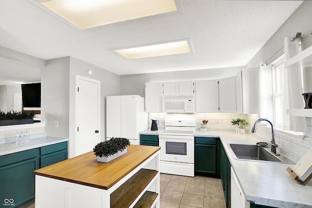 kitchen with white appliances, a sink, wood counters, a center island, and tasteful backsplash