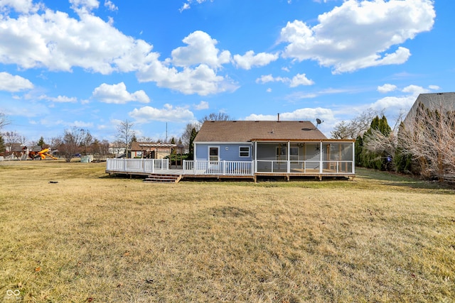 back of house with a sunroom, a lawn, and a deck