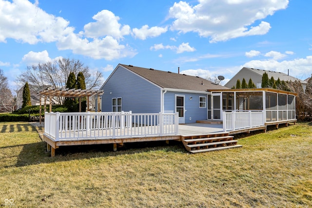 back of property featuring a lawn, a wooden deck, a sunroom, and a pergola