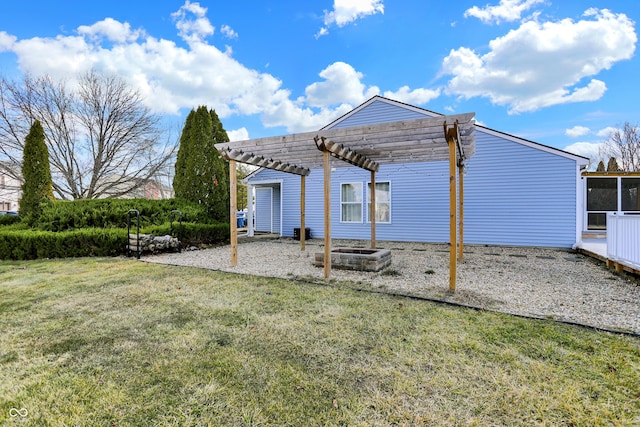 rear view of property with a yard, a carport, and a pergola