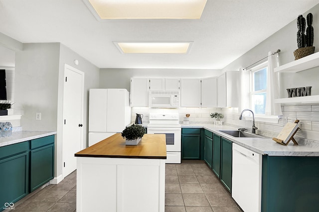 kitchen featuring backsplash, a sink, wood counters, white appliances, and green cabinetry