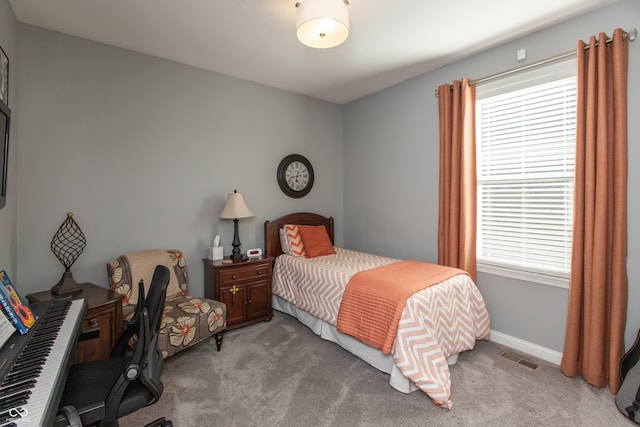 bedroom with visible vents, baseboards, and light carpet