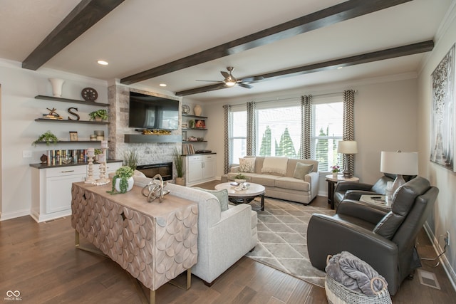 living room featuring beamed ceiling, a fireplace, dark wood-style flooring, and baseboards