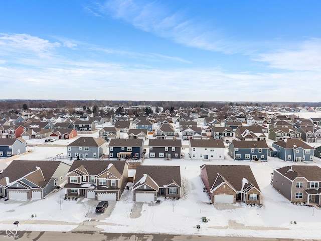 snowy aerial view with a residential view