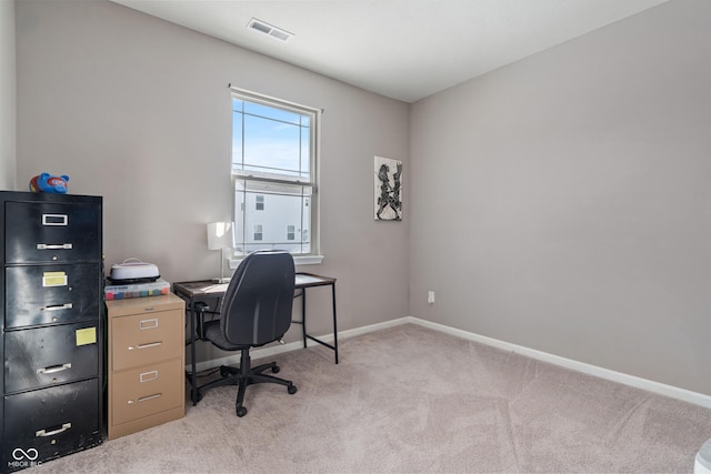 office featuring light carpet, baseboards, and visible vents