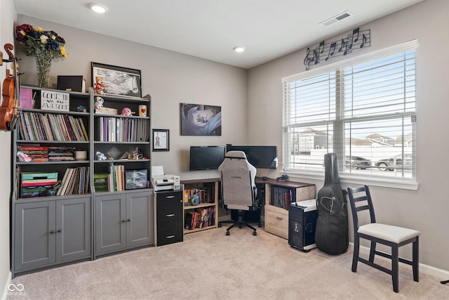 office space with light colored carpet, visible vents, and baseboards