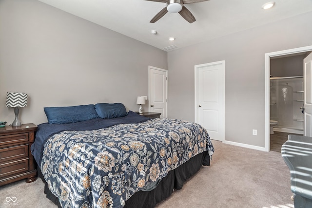 bedroom featuring visible vents, ensuite bathroom, a ceiling fan, light carpet, and baseboards