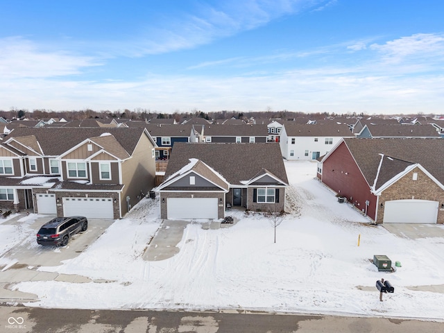 snowy aerial view featuring a residential view