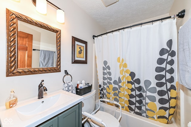 bathroom featuring a textured ceiling, toilet, and vanity