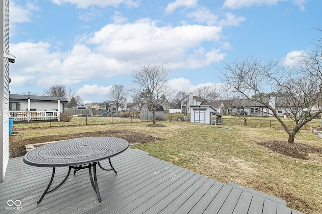 deck featuring a yard and a storage shed