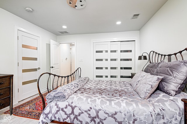 bedroom with visible vents, wood finished floors, and recessed lighting