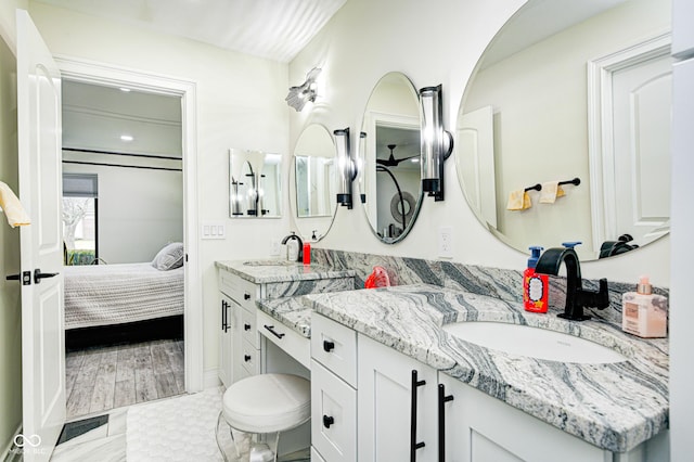 bathroom featuring ensuite bath and vanity