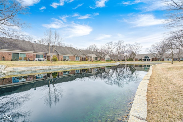 exterior space featuring a water view, a residential view, and a yard