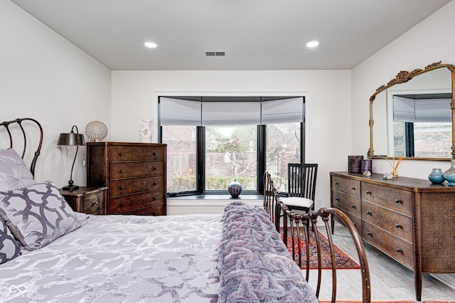 bedroom with visible vents, wood finished floors, and recessed lighting