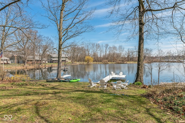 view of yard featuring a water view and a dock