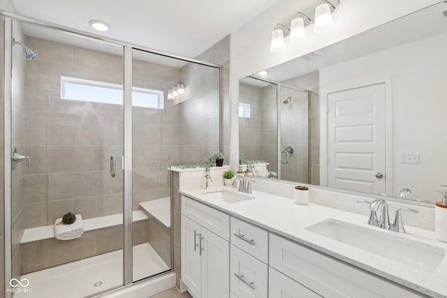 bathroom with vanity and a shower with shower door