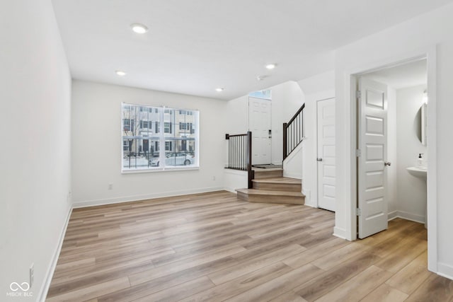 unfurnished living room featuring light wood-type flooring