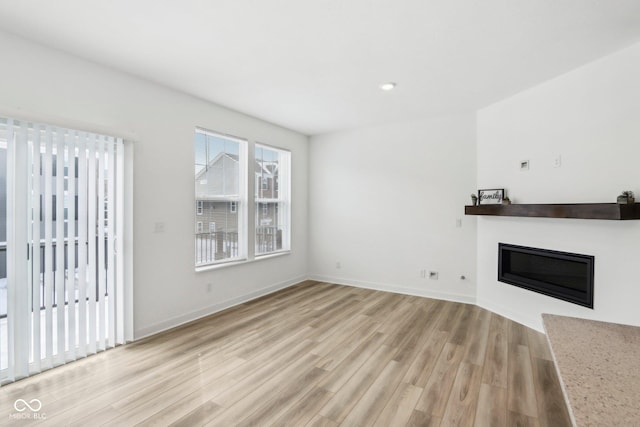 unfurnished living room with light hardwood / wood-style floors