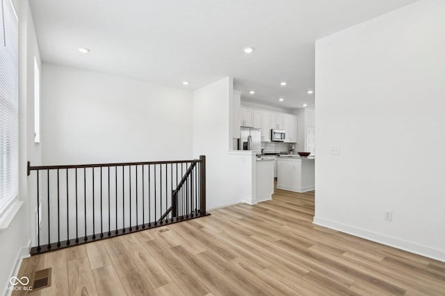 spare room featuring light wood-type flooring