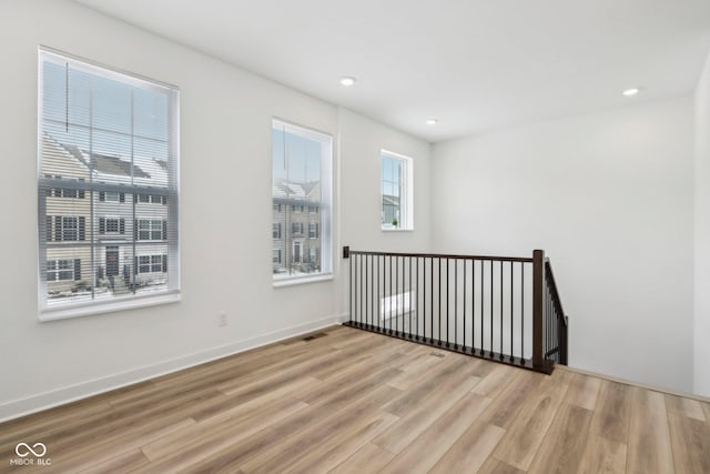 unfurnished room with hardwood / wood-style floors