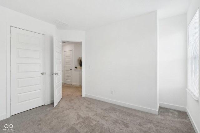 unfurnished bedroom with light carpet