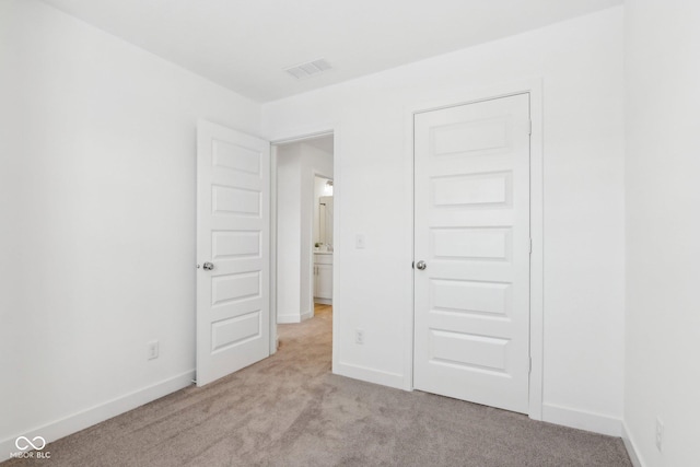 unfurnished bedroom featuring light colored carpet