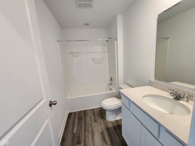 full bathroom with vanity, toilet, visible vents, tub / shower combination, and wood finished floors
