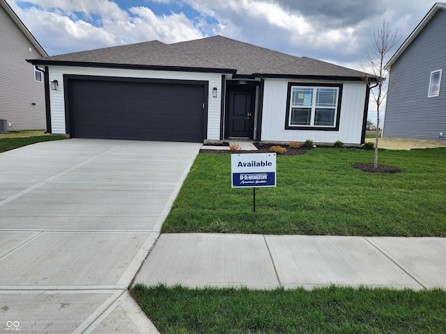 ranch-style house with a shingled roof, driveway, a front lawn, and an attached garage