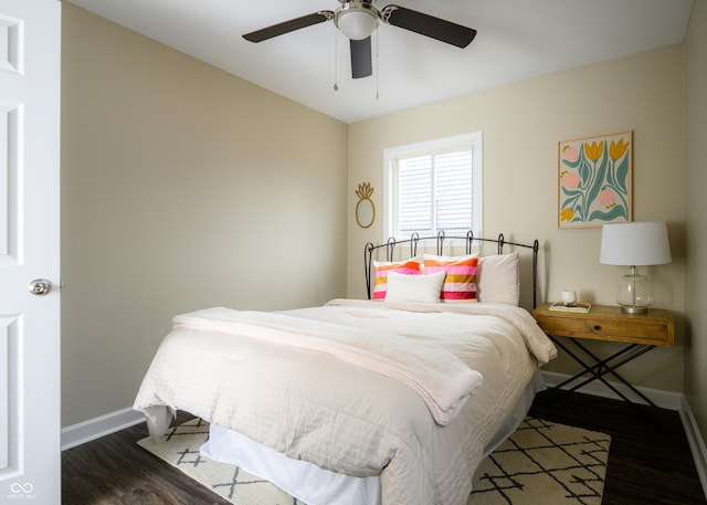 bedroom featuring ceiling fan, dark wood finished floors, and baseboards