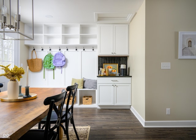 mudroom featuring dark wood-style floors and baseboards