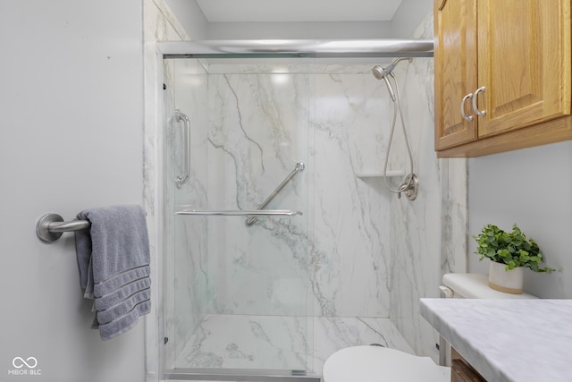 bathroom with vanity, toilet, and walk in shower