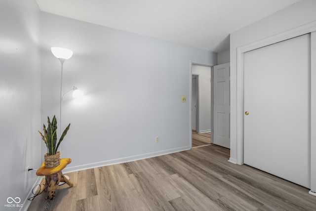 unfurnished bedroom with light hardwood / wood-style floors and a closet