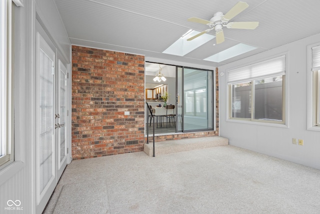 unfurnished sunroom featuring ceiling fan