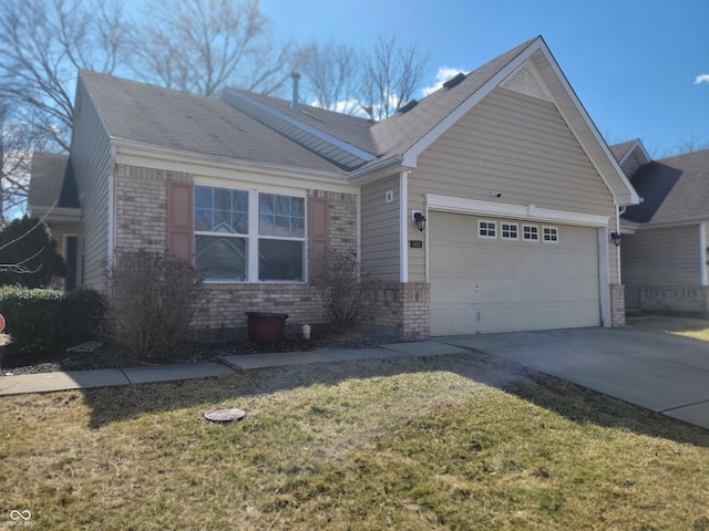 ranch-style house featuring brick siding, an attached garage, concrete driveway, and a front yard