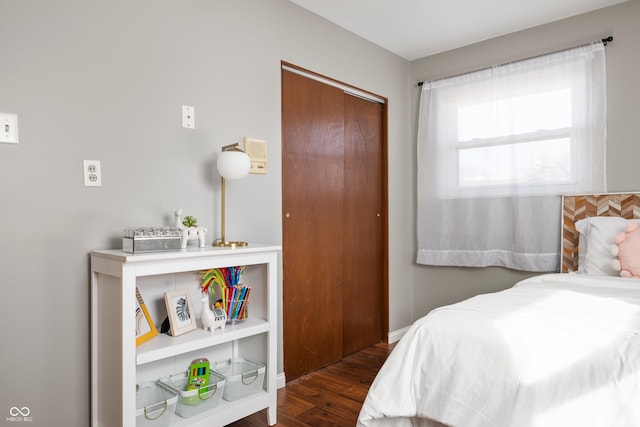 bedroom featuring a closet and dark wood finished floors