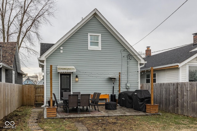 rear view of house featuring a patio area and a fenced backyard