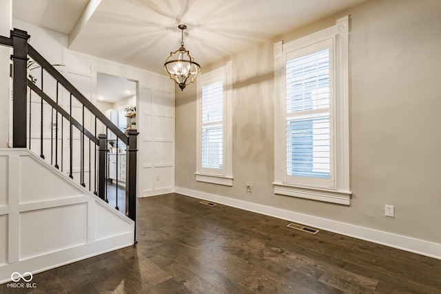 foyer with baseboards, stairs, visible vents, and dark wood-type flooring