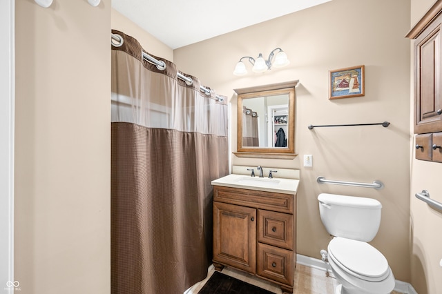 bathroom featuring toilet, vanity, and a shower with curtain