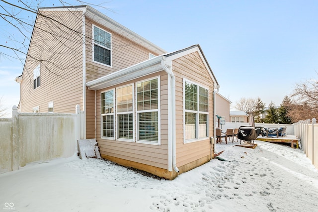 view of snow covered rear of property