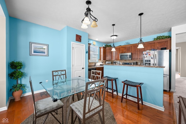 dining room with dark hardwood / wood-style floors