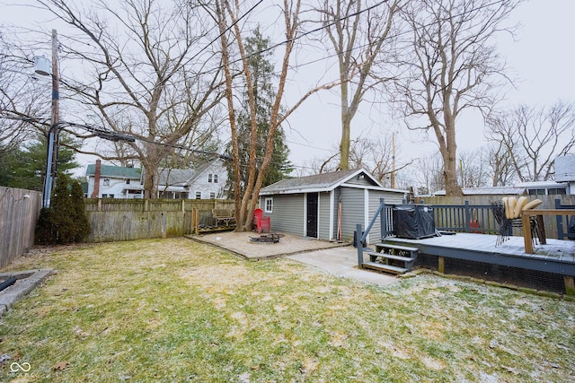 view of yard featuring an outdoor structure and a wooden deck