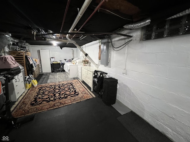 basement featuring electric panel and separate washer and dryer