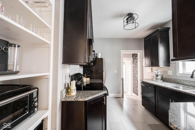 kitchen featuring sink, light stone counters, tasteful backsplash, and black appliances