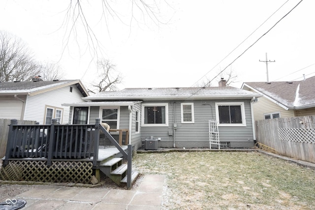 rear view of property with a lawn, central AC, and a wooden deck