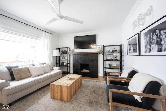 living room with ceiling fan, crown molding, light wood-type flooring, and a fireplace