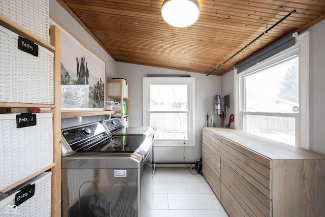 laundry area featuring washing machine and dryer, light tile patterned flooring, and wooden ceiling