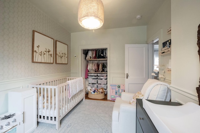 bedroom with a closet and a nursery area